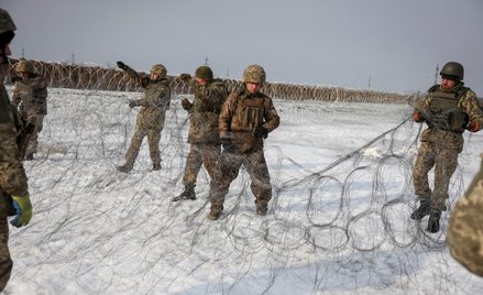 Ukraińscy żołnierze instalują drut kolczasty w pobliżu linii frontu w pobliżu Kupiańska