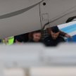 Sebastian M. opuszcza w asyście policji samolot po wylądowaniu na lotnisku Okęcie w Warszawie