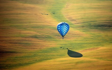 Balon lecący nad polami na obrzeżach Mińska podczas II Międzynarodowych Mistrzostw Lotnictwa. W mist