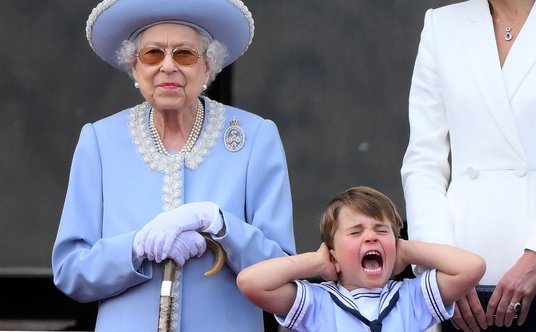 Królowa Elżbieta II i zasłaniający uszy podczas przelotu myśliwców książę Louis