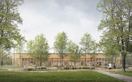 Budynek hali z elewacją w nturalnych kolorach ma łatwo się wkopmonować w zieleń Pola Mokotowskiego