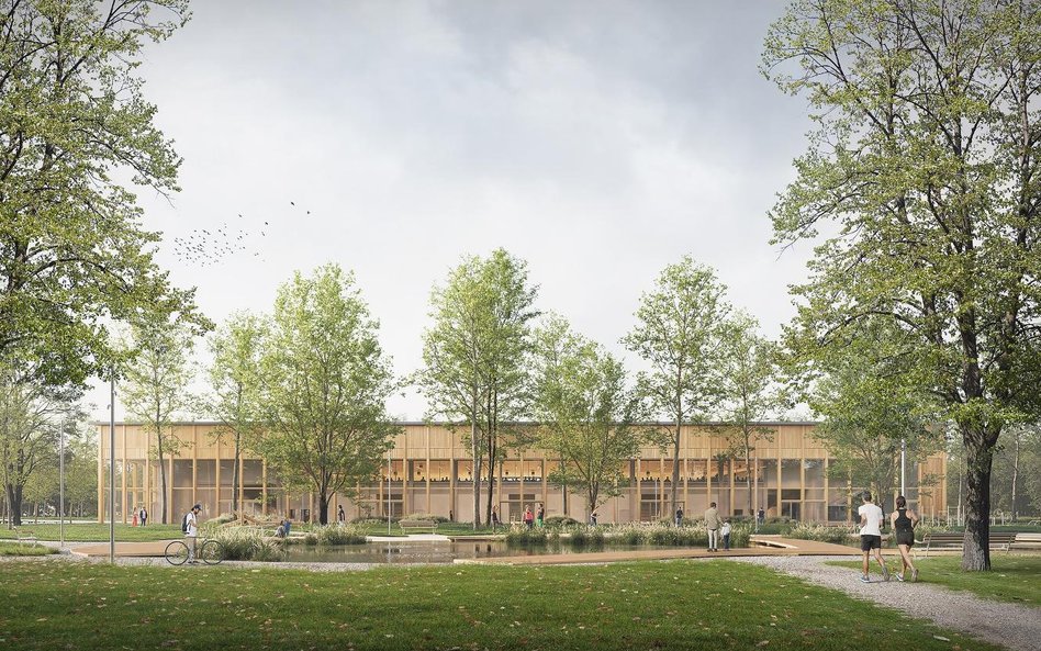 Budynek hali z elewacją w nturalnych kolorach ma łatwo się wkopmonować w zieleń Pola Mokotowskiego