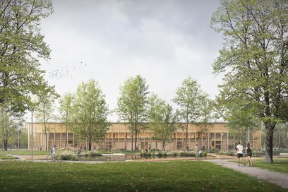 Budynek hali z elewacją w nturalnych kolorach ma łatwo się wkopmonować w zieleń Pola Mokotowskiego