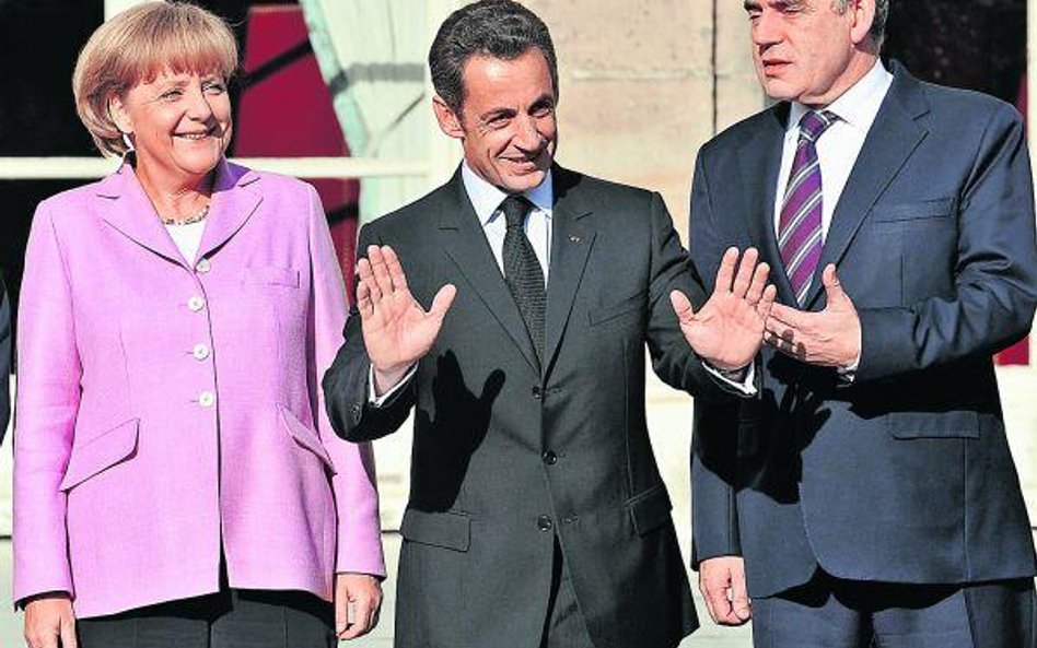 Niemiecka kanclerz Angela Merkel i francuski prezydent Nicolas Sarkozy (pośrodku) będą się starali p
