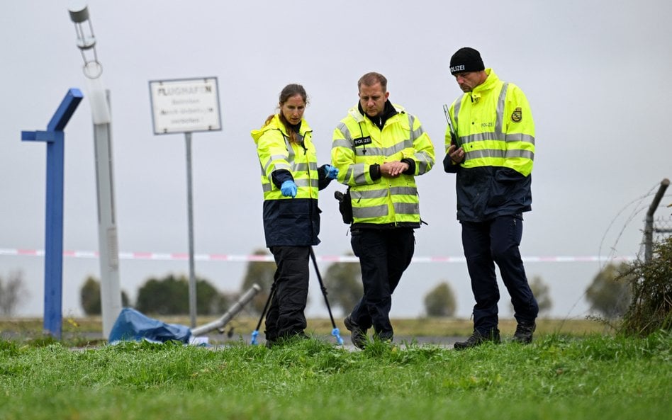 Funkcjonariusze policji badają uszkodzenie ogrodzenia na lotnisku Lipsk/Halle w Schkeuditz
