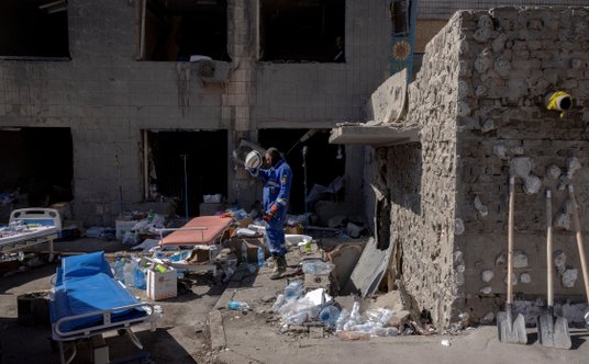 Ratownik na terenie zrujnowanego szpitala Ochmadyt w Kijowie