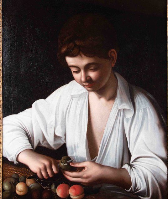 Obraz „Chłopiec obierający owoc” Caravaggia.