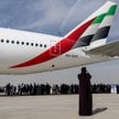 Uczestnicy oglądają pokazy akrobacyjne zespołu Al Fursan przy Boeingu 777-300ER, obsługiwanym przez 