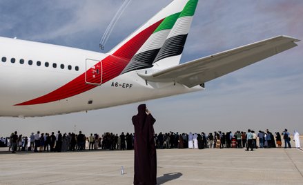 Uczestnicy oglądają pokazy akrobacyjne zespołu Al Fursan przy Boeingu 777-300ER, obsługiwanym przez 