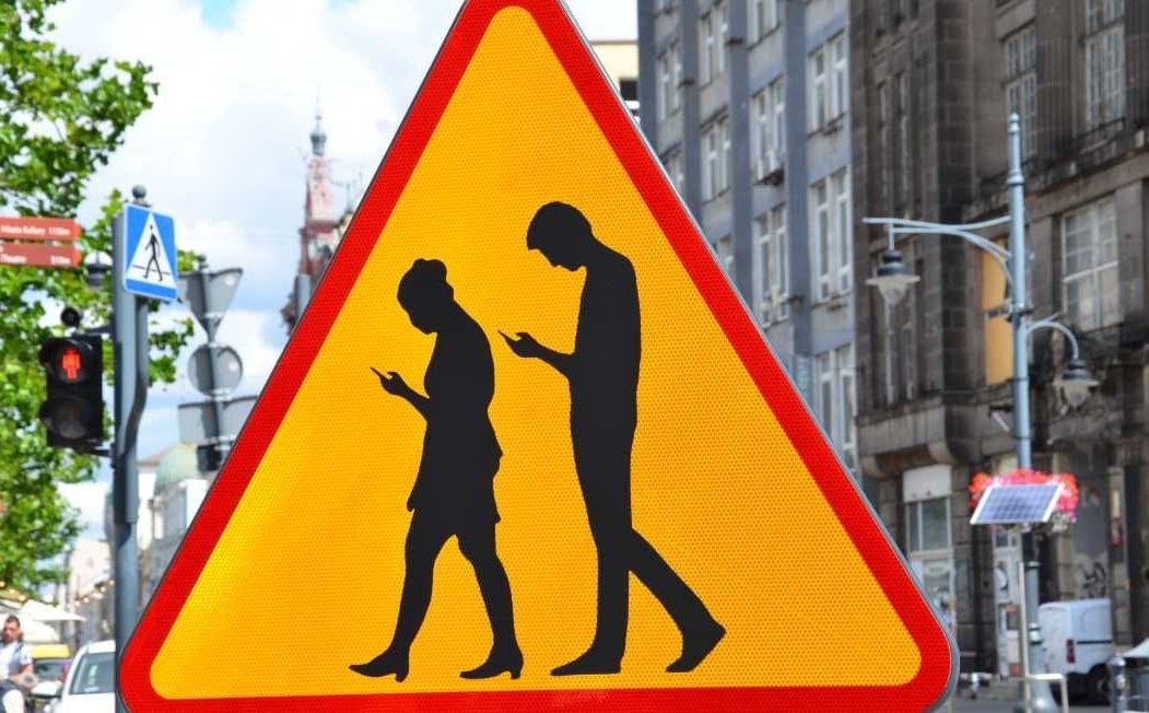 Caution: Pedestrians Staring at Their Smartphones. There’s a Call for a fresh  Traffic Sign