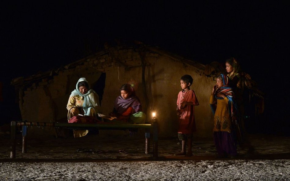 29 lutego, Indie. Młoda dziewczyna uczy się przy świecach. Tylko nieliczni mieszkańcy slumsów w Indi