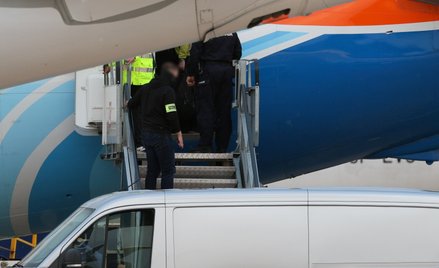 Funkcjonariusze policji opuszczają samolot linii lotniczej Flydubai po wylądowaniu na lotnisku Okęci