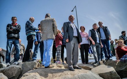 Mieszkańcy Dikili przyglądają się imigrantom wysiadającym po przybiciu do portu