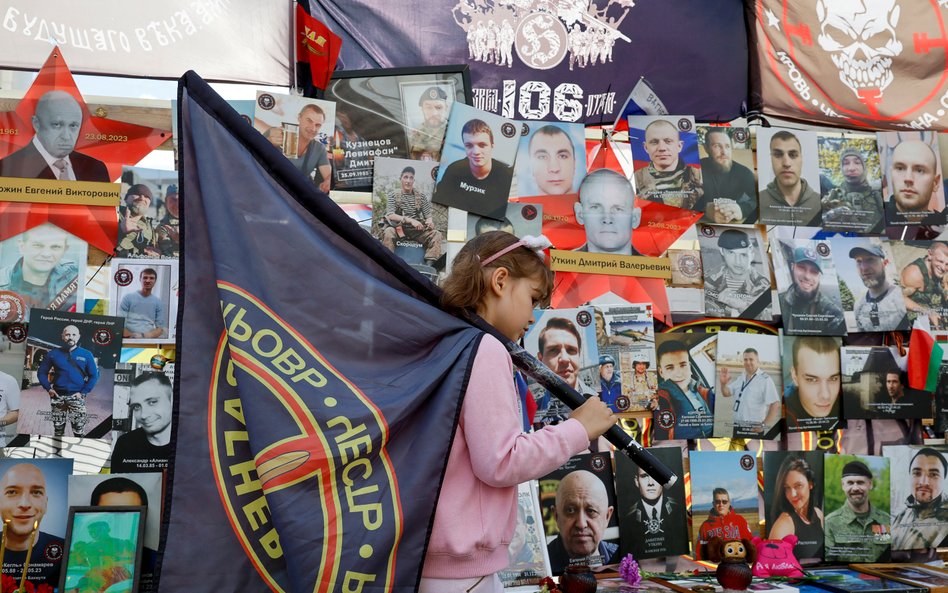 Córka poległego żołnierza rosyjskiej grupy najemników Wagnera, przed prowizorycznym pomnikiem, który