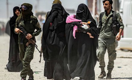 Obóz Al-Hol w północno-wschodniej Syrii. Kurdyjskie strażniczki eskortują żony dżihadystów
