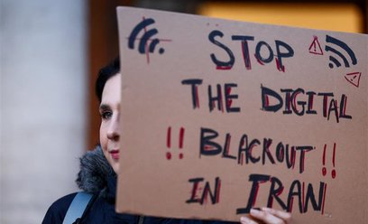 Kobieta trzymająca transparent podczas wiecu poparcia dla ogólnokrajowych protestów w Iranie, Rzym.