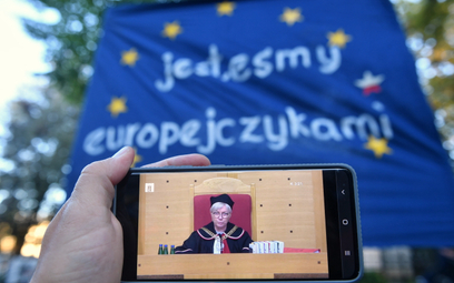 Prezes Trybunału Konstytucyjnego Julia Przyłębska podczas obrad oglądanych na ekranie smartfona prze