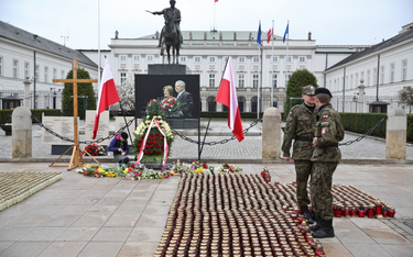Harcerka ustawia znicze przed Pałacem Prezydenckim przy Krakowskim Przedmieściu w Warszawie