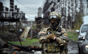 Rosyjski żołnierz przed elektrownią w miejscowości Szczastia w obwodzie ługańskim