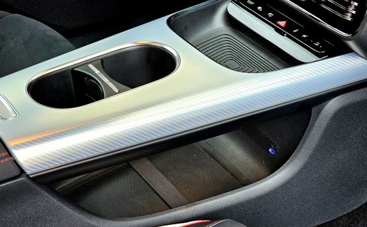 Tunel środkowy z miejscem na kubki, telefon i ze sporym schowkiem