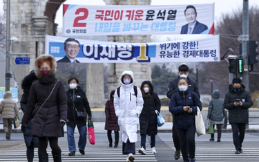 Koreańczycy w maskach na ulicy w Seulu