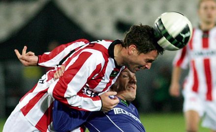 Arkadiusz Radomski (z lewej) walczy o piłkę z Andrazem Kirmem z Wisły