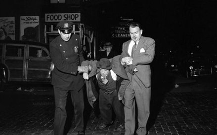 Man Being Dragged by Cops Night. ©Vivian Maier/Maloof Collection