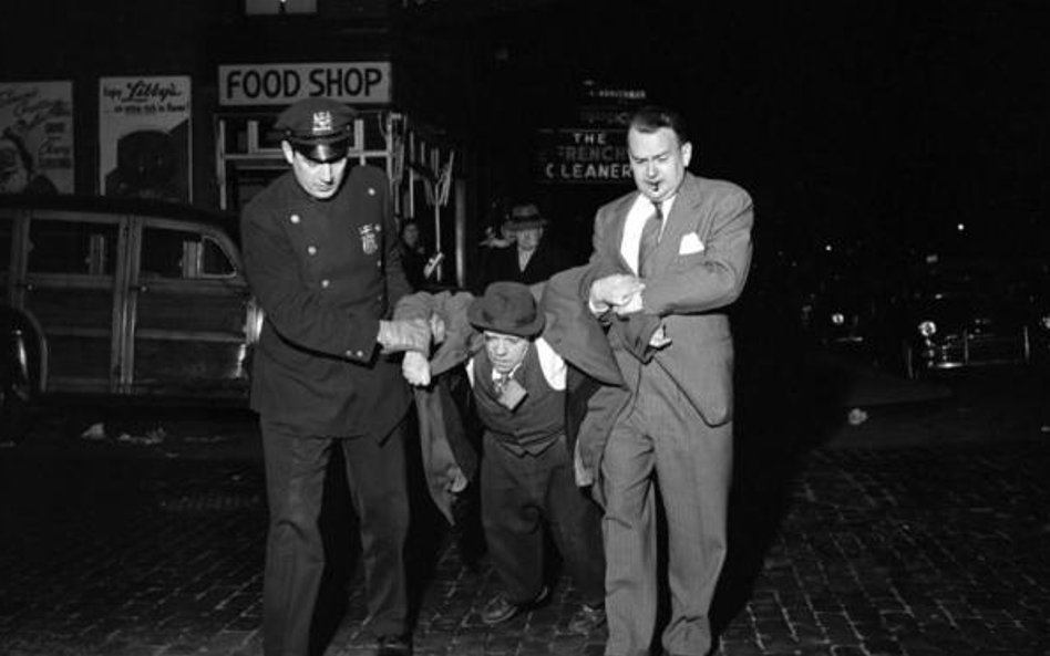 Man Being Dragged by Cops Night. ©Vivian Maier/Maloof Collection