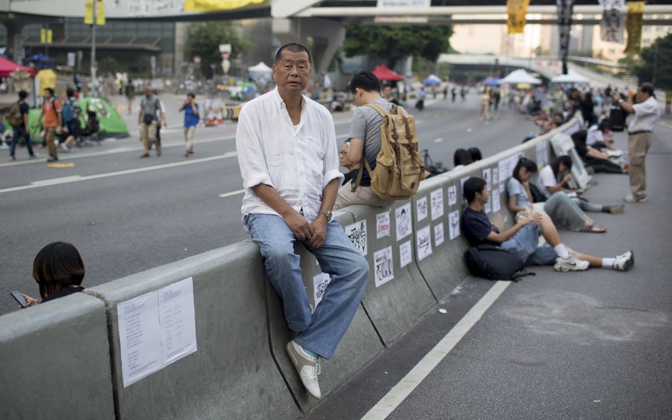 Jimmy Lai pozuje do zdjęcia wśród demonstrantów przed siedzibami rządu centralnego w Hongkongu w Chi