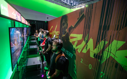 Odwiedzający grają w Cyberpunk 2077 na stoisku Microsoft Xbox podczas konwencji gier Gamescom w Kolo