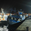 Statek z migrantami na nabrzeżu na włoskiej wyspie Lampedusa