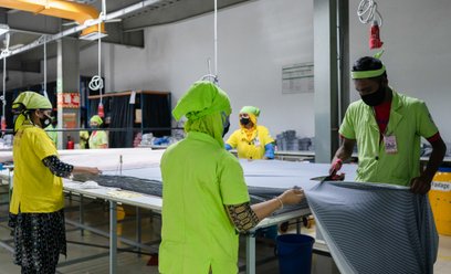 Pracownik tnie kawałek materiału w fabryce odzieży Urmi Group w Narayanganj w Bangladeszu