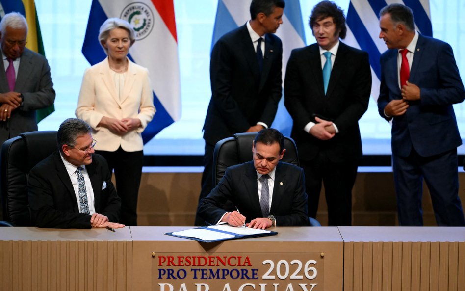 Minister spraw zagranicznych Paragwaju Ruben Ramirez Lezcano podpisuje dokument w towarzystwie komis