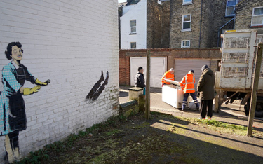 Pracownicy służb miejskich usuwają lodówkę, kluczowy element instalacji przygotowanej przez Banksy'e