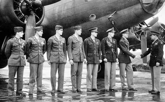 Curtis E. LeMay składa gratulacje załodze bombowca 306. grupy bombowej. Załoga stoi przed latającą f