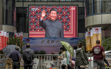 Prezydent Xi Jinping pozdrawia z ulicznego ekranu z okazji 70-lecia Chin Ludowych