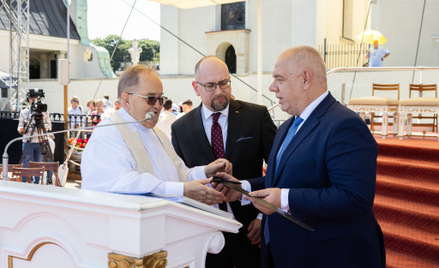 Minister aktywów państwowych Jacek Sasin i prezes Enei Paweł Majewski wręczają o. Tadeuszowi Rydzyko