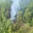 Dym unosi się nad miejscem katastrofy samolotu pasażerskiego An-24 linii Angara Airlines w pobliżu T