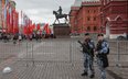 Funkcjonariusze policji przed barierami chroniącymi Plac Czerwony w Moskwie na dzień przed paradą w 