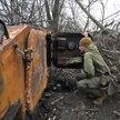 Ukraiński żołnierz przy zniszczonym rosyjskim transporterze