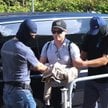 Inwestor giełdowy Rafał Zaorski (C) doprowadzany do delegatury Prokuratury Krajowej w Katowicach