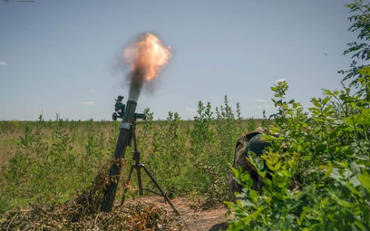 Ukraiński żołnierz w czasie prowadzenia ognia z moździerza