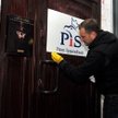 Poseł PO Sławomir Nitras zmywa farbę z drzwi biura PiS w Szczecinie