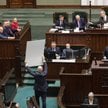 Posłowie PiS z banerami na sali plenarnej Sejmu