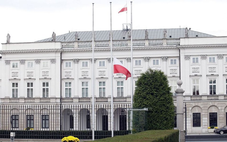 Opuszczona do połowy masztu flaga przed Pałacem Prezydenckim