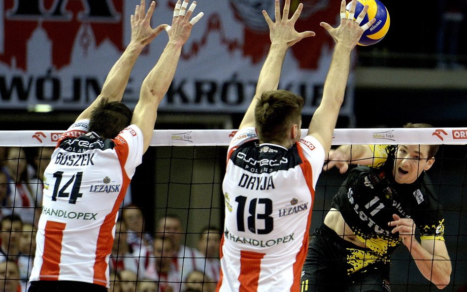 Rafał Buszek (L) i Dawid Dryja (C) blokują po ataku Murphy'ego Troy'a (P) z Lotosu Trefl Gdańsk.