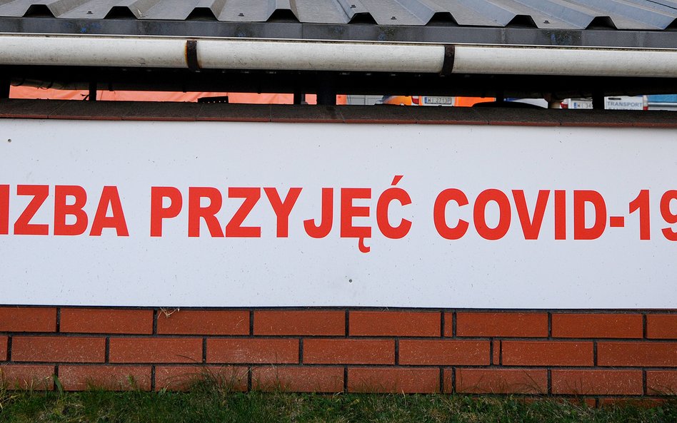 Tablica z napisem "Izba przyjęć COVID-19" przed szpitalem w Warszawie