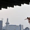 Chiny, Wuhan. Mężczyźni dla ochrony przed upałem skaczą z mostu do rzeki Jangcy