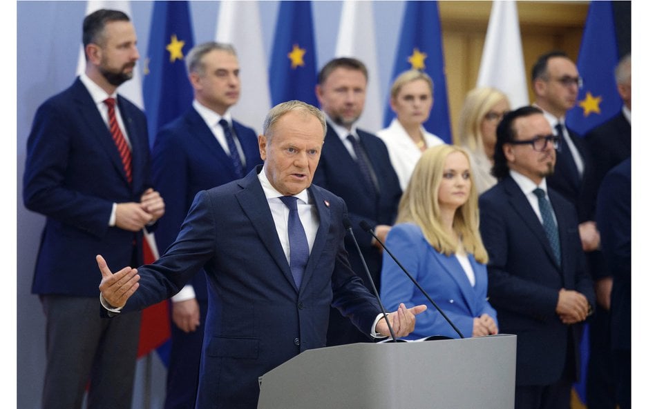 Polish Prime Minister Donald Tusk speaks as he participates in a press briefing regarding a governme